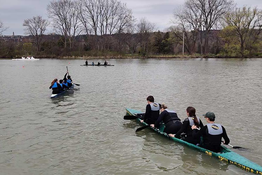 Students testing the concrete canoes on the water